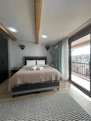 a bedroom with a large bed and a large window at NarPera Taksim Boutique Hotel in Istanbul
