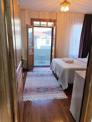 a bedroom with a bed and a door with a window at NarPera Taksim Boutique Hotel in Istanbul