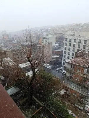 a snow covered city with a tree and buildings at NarPera Taksim Boutique Hotel in Istanbul