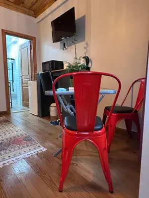 a red table and chairs in a living room at NarPera Taksim Boutique Hotel in Istanbul