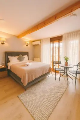 a bedroom with a bed and a table and chairs at NarPera Taksim Boutique Hotel in Istanbul