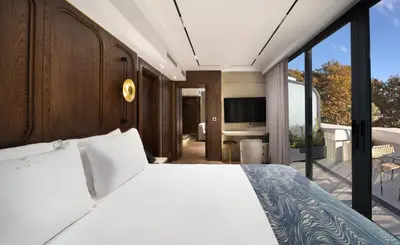 a bedroom with a white bed and a balcony at Bentley Hotel Old City-Special Class in Istanbul