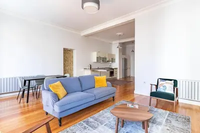 a living room with a blue couch and a table at Warm Rustic Charming 2BD Galata wPatio Gem! #320 in Istanbul