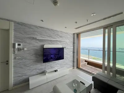 a living room with a tv on a wall at Exquisite Ottomare Suites in Istanbul