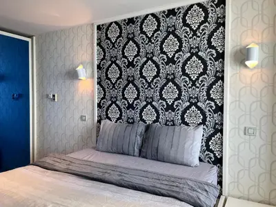 a bedroom with a bed with a black and white headboard at Exquisite Ottomare Suites in Istanbul