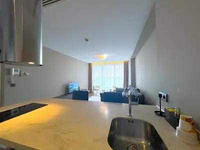 a kitchen with a sink and a living room at Exquisite Ottomare Suites in Istanbul