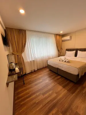 a bedroom with a large bed and wooden floors at Taksim Nacre 360 Suit in Istanbul