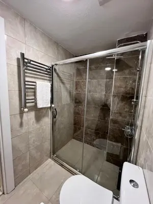 a bathroom with a shower and a toilet at Taksim Nacre 360 Suit in Istanbul