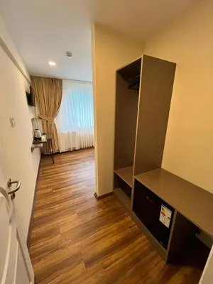 a hallway of a room with a mirror and wooden floor at Taksim Nacre 360 Suit in Istanbul
