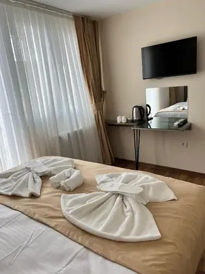 a bed with two white towels on top of it at Taksim Nacre 360 Suit in Istanbul