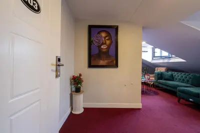 a hallway with a painting of a woman on the wall at Süper Stay Halkalı in Istanbul