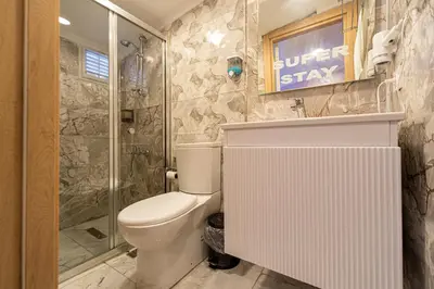 a bathroom with a toilet and a shower at Süper Stay Halkalı in Istanbul