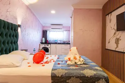 a bedroom with a bed with a stuffed animal on it at Süper Stay Halkalı in Istanbul