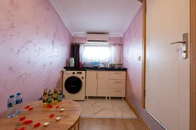 a small kitchen with a table and a washing machine at Süper Stay Halkalı in Istanbul