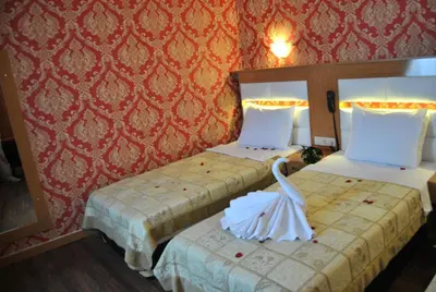 two beds in a hotel room with a swan on them at Hotel Star Park in Istanbul
