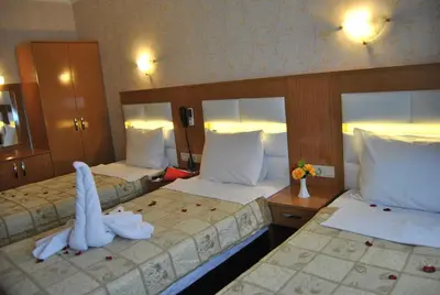 two beds in a hotel room with towels on them at Hotel Star Park in Istanbul