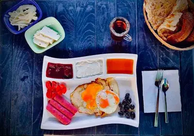 a tray of food with an egg and other foods at Amür hotel 7 in Istanbul