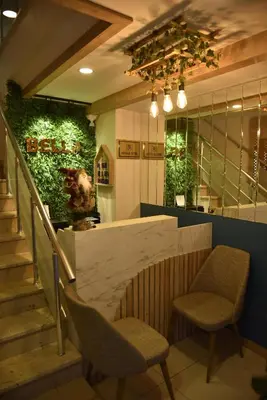 a lobby with two chairs and a counter and stairs at Bella Otel Mudanya in Mudanya