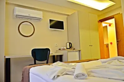 a hospital room with a bed and a chair at Yesilirmak Aparts in Istanbul