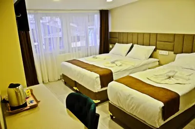 a hotel room with two beds and a window at Yesilirmak Aparts in Istanbul