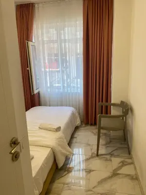 a room with a bed and a chair and a window at YENİkapı in Istanbul