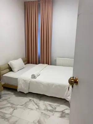 a bedroom with a white bed with a window at YENİkapı in Istanbul