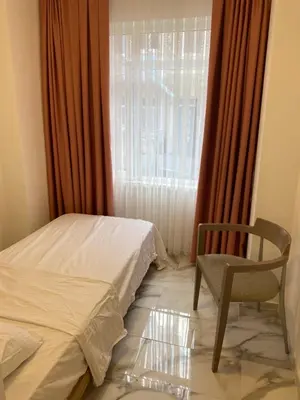 a bedroom with a bed and a chair and a window at YENİkapı in Istanbul