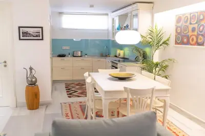 a dining room with a white table and chairs at Duplex Modern City Gem with Terrace in Istanbul