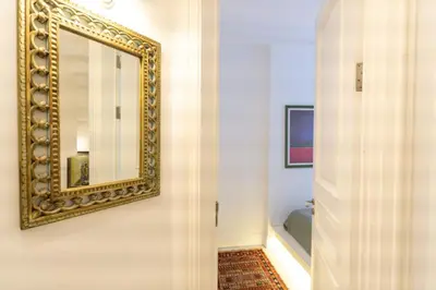 a bathroom with a mirror on the wall and a hallway at Duplex Modern City Gem with Terrace in Istanbul