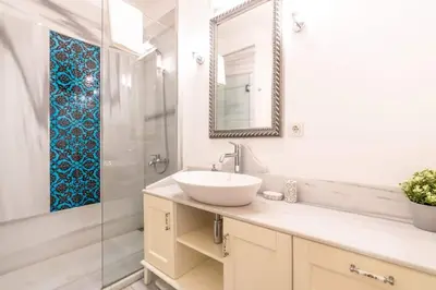 a white bathroom with a sink and a mirror at Duplex Modern City Gem with Terrace in Istanbul