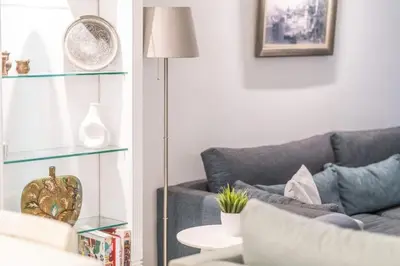a living room with a couch and a lamp at Duplex Modern City Gem with Terrace in Istanbul