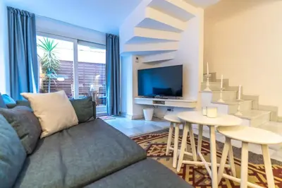 a living room with a couch and a table at Duplex Modern City Gem with Terrace in Istanbul