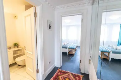 a room with two beds and a mirror at Stylish Duplex in Beyoğlu with Private Terrace in Istanbul