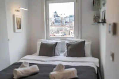 a bed in a room with two pairs of shoes on it at Stylish Duplex in Beyoğlu with Private Terrace in Istanbul