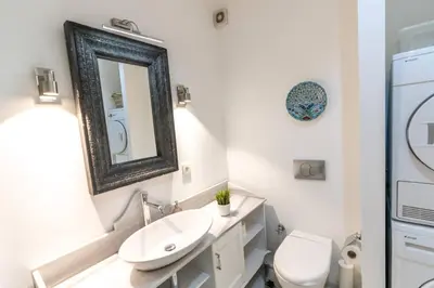 a bathroom with a sink and a toilet and a mirror at Cozy Getaway - Warmth and Comfort in the City in Istanbul