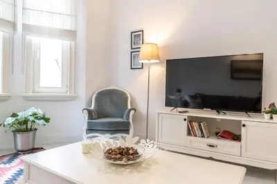 a living room with a chair and a television at Cozy Getaway - Warmth and Comfort in the City in Istanbul