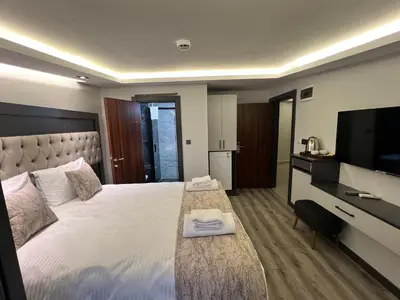 a hotel room with a bed and a flat screen tv at Golden Stoneluxe İstanbul Hotel in Istanbul