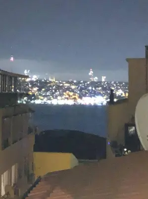 a view of a city at night with the water at 5 Min Walk Distance Taksim Square Semi Sea View in Istanbul