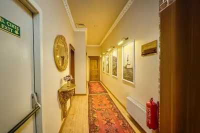a hallway with a rug on the floor and a door at BeyPort Hotel Istanbul in Istanbul