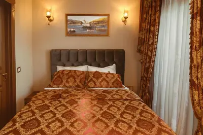 a bedroom with a bed with a orange bedspread at BeyPort Hotel Istanbul in Istanbul