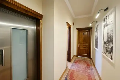 a hallway with a door and a rug at BeyPort Hotel Istanbul in Istanbul