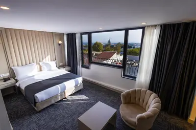 a hotel room with a bed and a large window at Moss Hotel YENİKAPI in Istanbul