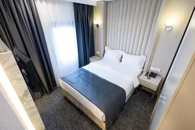 a hotel room with a bed and a window at Moss Hotel YENİKAPI in Istanbul