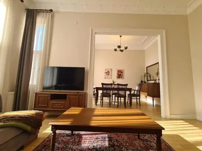 a living room with a table and a television at Elegant, spacious, quiet 3br near historic center in Istanbul