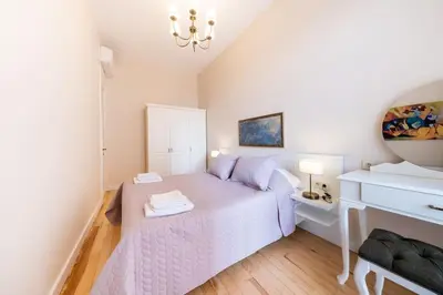 a bedroom with a white bed and a white piano at Elegant, spacious, quiet 3br near historic center in Istanbul