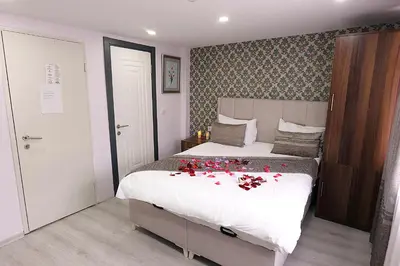 a bedroom with a bed with red flowers on it at Pera Apart in Istanbul
