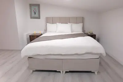 a bedroom with a large bed with white sheets and pillows at Pera Apart in Istanbul