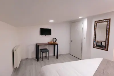 a bedroom with a table and a mirror and a bed at Pera Apart in Istanbul