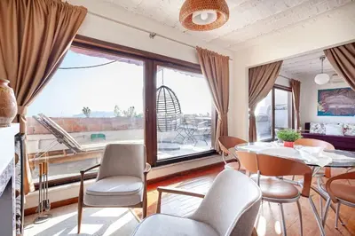 a dining room with a table and chairs and a large window at Magnificent view, in the center in Istanbul