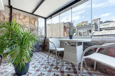 a patio with chairs and a table on a balcony at Prime location with terrace in Istanbul